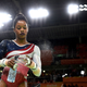Gabby Douglas sprays in preparation for competing on the uneven bars during the Artistic Gymnastics Women’s Team Final on day 4 of the Rio 2016 Olympic Games at the Rio Olympic Arena on Aug. 9, 2016, in Rio de Janeiro.
Laurence Griffiths/Getty Images